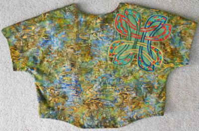 Back of batik vest with Danu block reverse appliqued on shoulder.